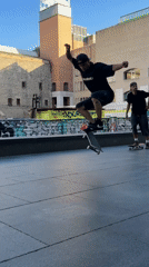 Skateboarders perform tricks at Barcelona plaza during evening session