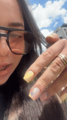 Woman shows off decorated yellow manicure in Varna