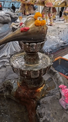 Ornate multi-tiered water feature observed with cultural decorative elements