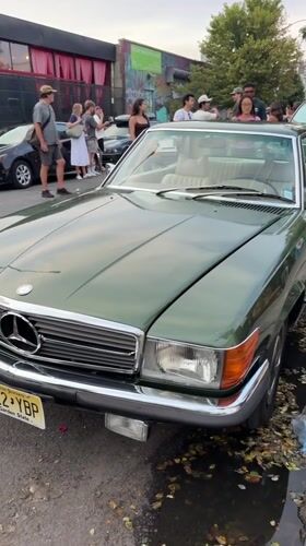 Dark green Mercedes-Benz SL parked on a New York street