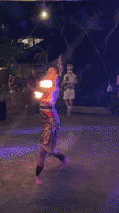 Traditional fire dance performance at nighttime outdoor event in Kuta