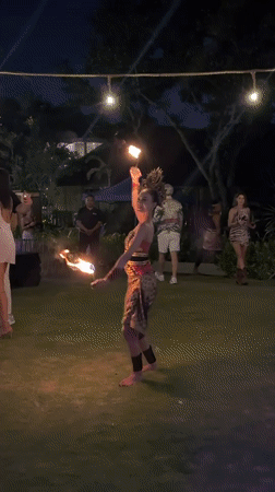 Traditional fire dance performance at nighttime outdoor event in Kuta