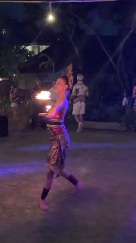 Traditional fire dance performance at nighttime outdoor event in Kuta