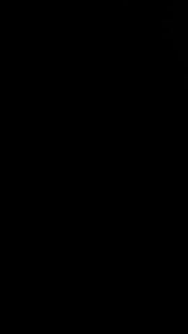 The video shows the dashboard of a car at night. The interior is dark, with the dashboard lights dimly illuminated in red and green. A bright flash of light momentarily illuminates the windshield, revealing the road ahead. The loud music is playing throughout the video.