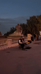 Evening Barcelona cityscape and street musician captured from Montjuïc viewpoint