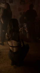 Woman dances, photographs moments at crowded Moscow bar