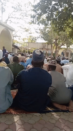 Men gather outside mosque in Kano, Nigeria