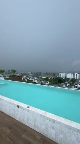 Rooftop pool captured during rainy morning in Choeng Thale
