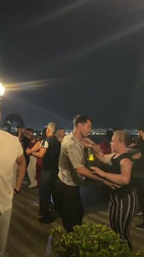 Rooftop dancing under Baku city lights on a warm summer night