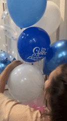 Woman arranges blue and white balloon bouquet in Cheboksary