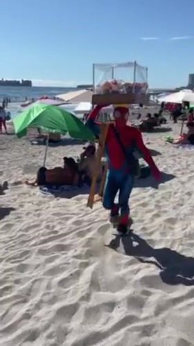 Spider-Man vendor serves beachgoers in Iquique, Chile
