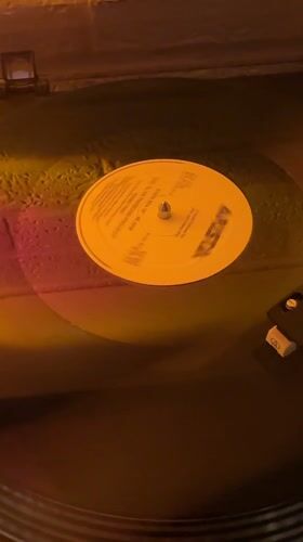Vinyl record spinning on turntable captured in Cholula