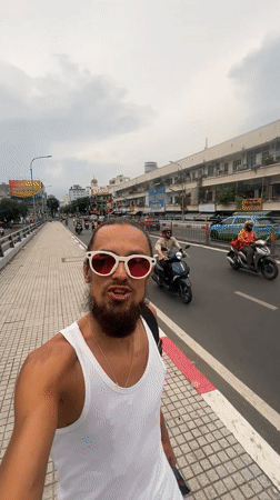 Strolling a busy street under clear skies