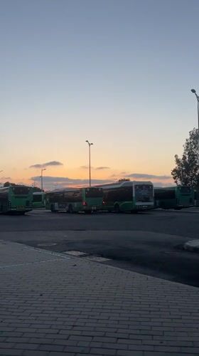 Evening bus depot scene captured at dusk in Kiryat Motzkin