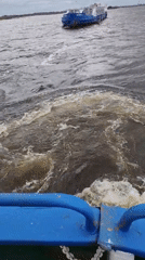 Boat journey documented on overcast water body