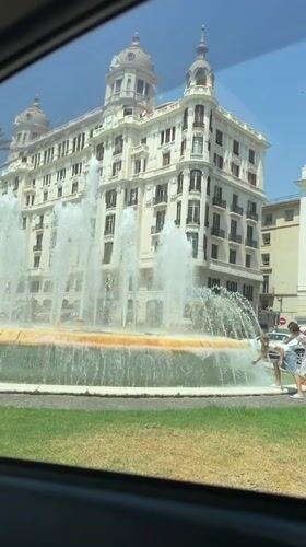 Ornate domed building and fountain in central Alicante