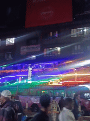 Colorful LED buses illuminate busy Nairobi street at night