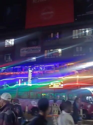 Colorful LED buses illuminate busy Nairobi street at night