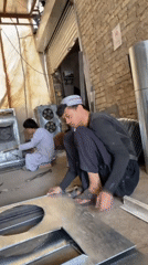 Workers craft air coolers in Kandahar metal workshop
