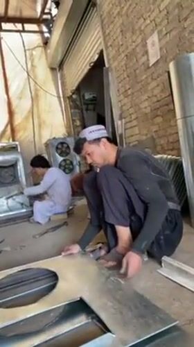Workers craft air coolers in Kandahar metal workshop