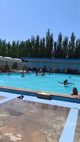 Crowded outdoor pool day in Voskehat, Armenia