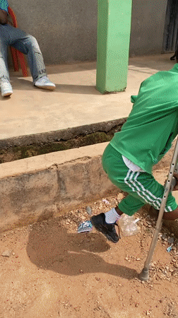 Children in tracksuits gather at building in Gura Top
