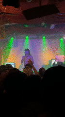 Concert performer with white makeup filmed by audience member