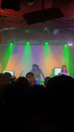 Concert performer with white makeup filmed by audience member