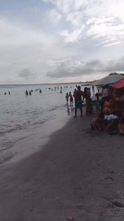 Crowded beach afternoon at Porlamar under overcast skies