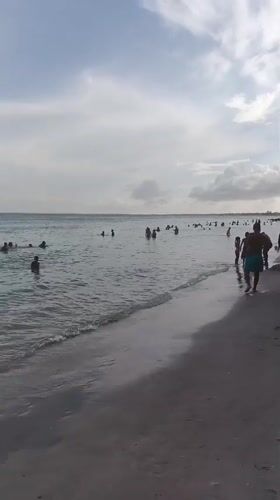 Crowded beach afternoon at Porlamar under overcast skies