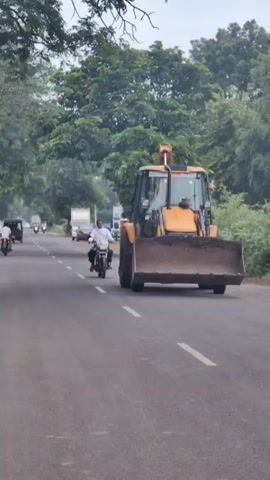 A video compilation shows a two-lane road with vehicles and trees. The first clip shows a yellow bulldozer on the right side of the road, with a motorcycle passing it in the left lane. The second clip shows a wider view of the road with several motorcycles and a white truck. The third clip shows a motorcycle and a small truck on the road, with trees lining both sides. The fourth clip shows a motorcycle and a small truck in the distance, with trees on both sides of the road. The final clip shows a motorcycle in the distance on the road, with trees on both sides. The sky is overcast in all clips, suggesting it might be a cloudy day.