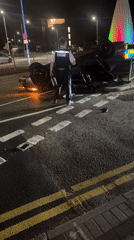 Overturned car on London road with police on scene