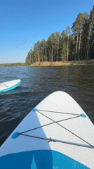Woman enjoys sunny paddleboarding session on Russian lake