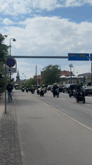 Motorcycle procession rides through Copenhagen streets in coordinated group