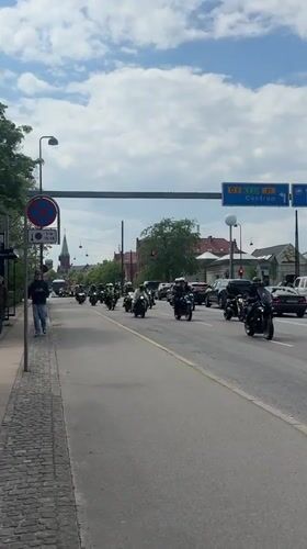 Motorcycle procession rides through Copenhagen streets in coordinated group