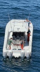 Fishing crew spotted on white motorboat in open waters