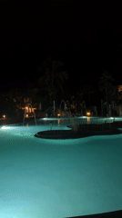 Night pool scene with fountains captured in Las Jarretaderas