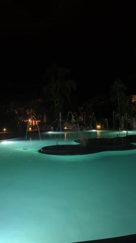 Night pool scene with fountains captured in Las Jarretaderas