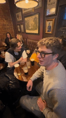 Young people socialize at London pub Thursday evening