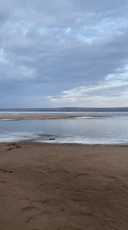 Waterfront gathering documented in Chaikovsky, Russia amid spring thaw