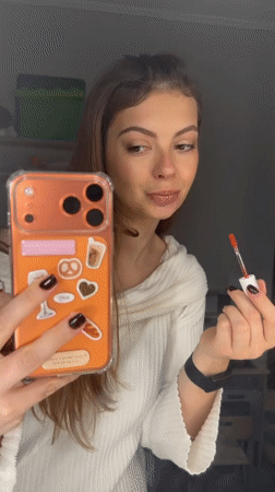 Woman records makeup routine with phone in Khimki