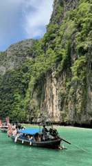 Tourist boats navigate scenic limestone cliffs in Ao Nang bay