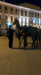 Evening street scenes and statue interactions documented in Minsk