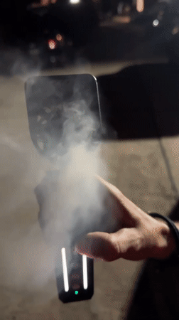 Person uses vapor-producing electronic device in Choeng Mon, Thailand