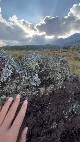 Tourists explore misty Kintamani highlands on motorcycles and foot