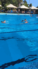 Busy summer day at Sochi's Zhemchuzhina hotel beach and pool