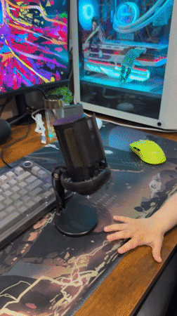 Toddler explores computer setup in Russian home office