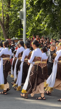 Traditional Balinese procession with musicians and ceremonial floats in Denpasar