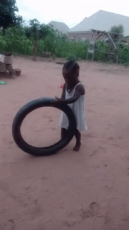 Kids playing with tires on a quiet morning in Howayi