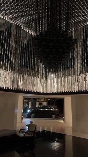 Dark sculptural chandelier anchors a dramatic interior in Kuta Selatan